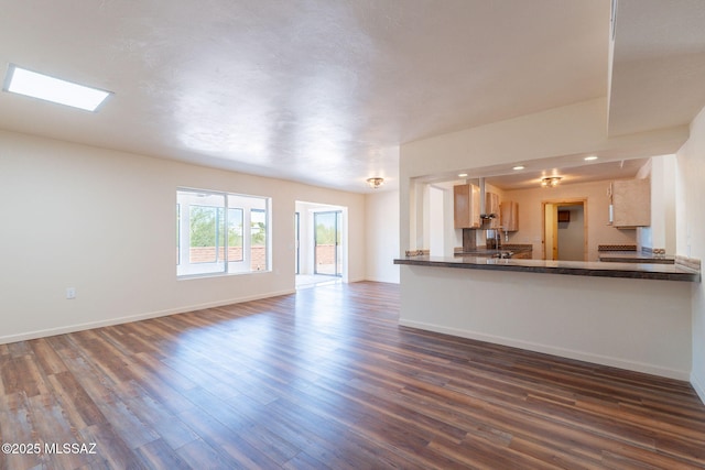 912 S Las Lomas Cir, Green Valley, AZ 85614 - unfurnished living room featuring baseboards and dark wood-type flooring