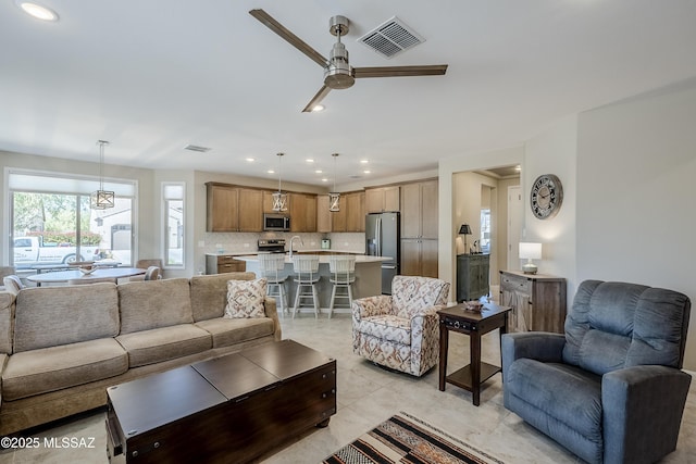 living room with light tile patterned floors, visible vents, recessed lighting, and ceiling fan