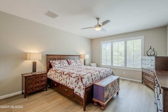 bedroom featuring visible vents, light wood-style flooring, baseboards, and a ceiling fan