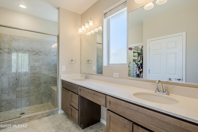 full bathroom with a shower stall, a sink, and plenty of natural light