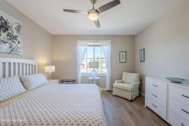 bedroom with baseboards, a ceiling fan, and wood finished floors