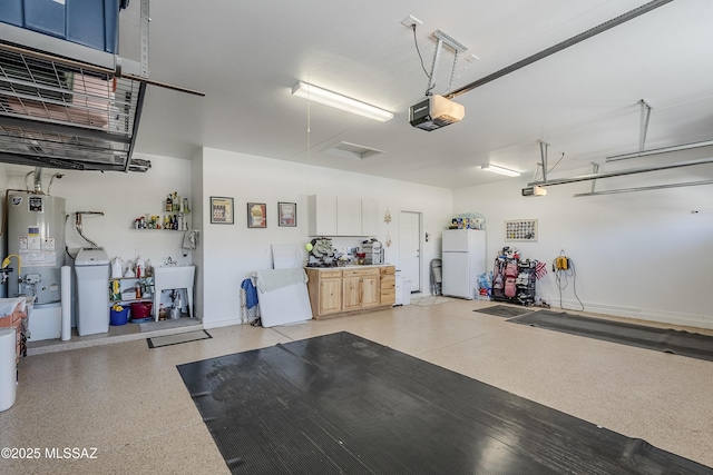 garage with baseboards, water heater, a garage door opener, and freestanding refrigerator
