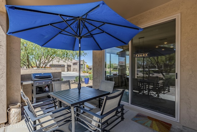 view of patio with outdoor dining area and grilling area