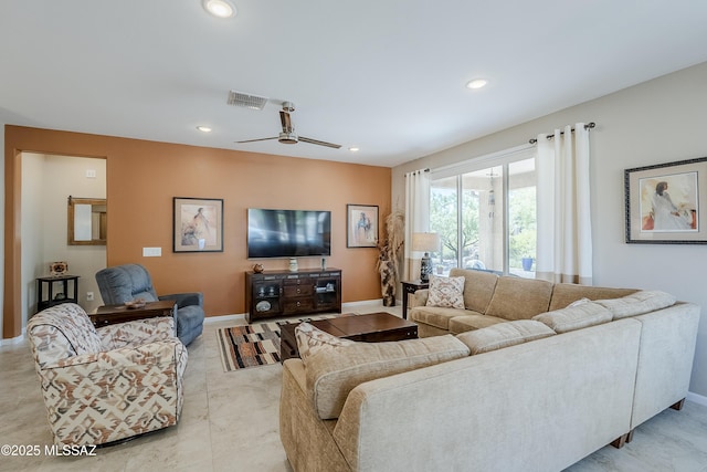 living area with baseboards, visible vents, and recessed lighting