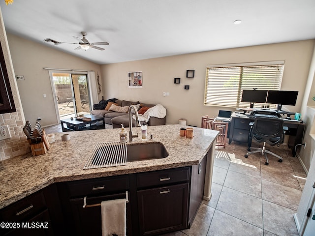 kitchen with visible vents, a ceiling fan, a sink, a peninsula, and open floor plan