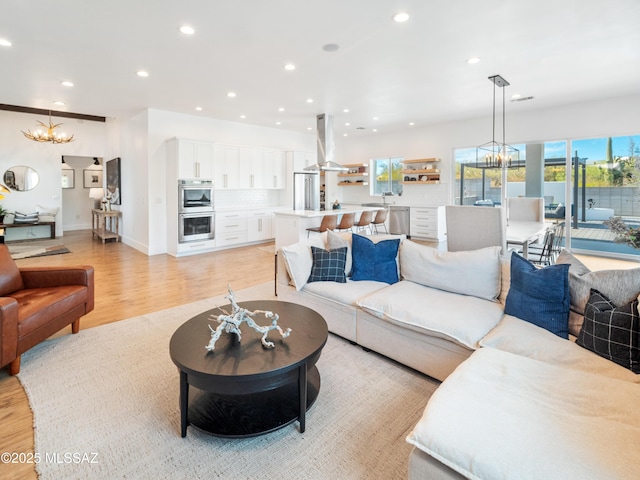 2540 W Oasis Springs Ct, Tucson, AZ 85742 - living room featuring an inviting chandelier, recessed lighting, and light wood-style flooring