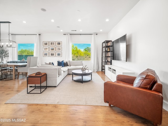 2540 W Oasis Springs Ct, Tucson, AZ 85742 - living room featuring plenty of natural light, recessed lighting, light wood finished floors, and a notable chandelier