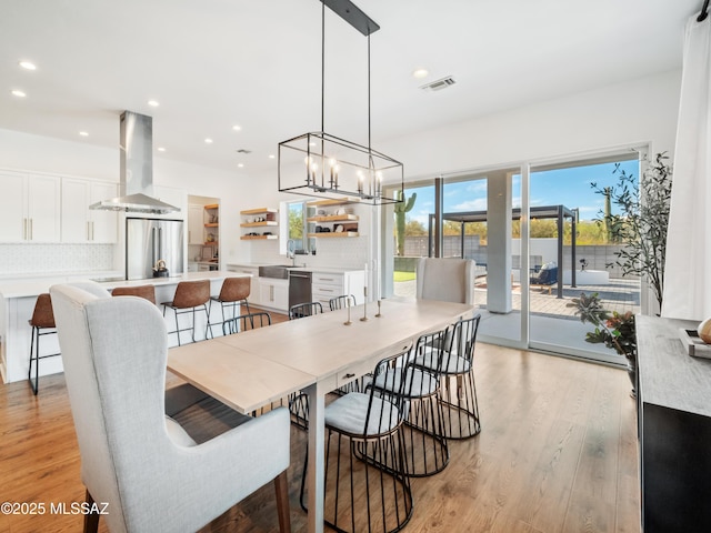 2540 W Oasis Springs Ct, Tucson, AZ 85742 - dining space with an inviting chandelier, recessed lighting, light wood finished floors, and visible vents