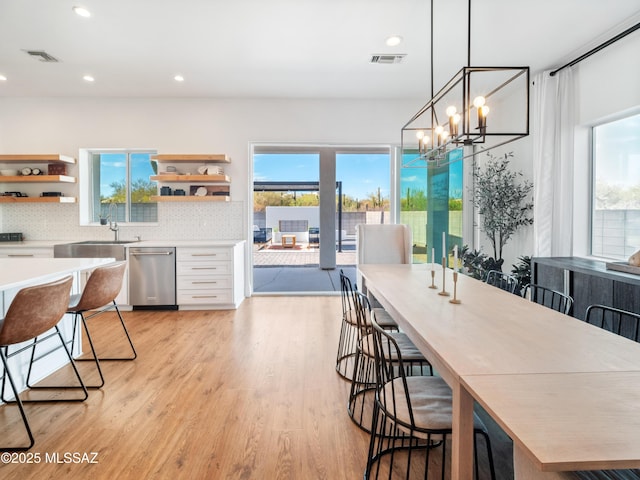 2540 W Oasis Springs Ct, Tucson, AZ 85742 - dining area with a notable chandelier, recessed lighting, light wood-style flooring, and visible vents