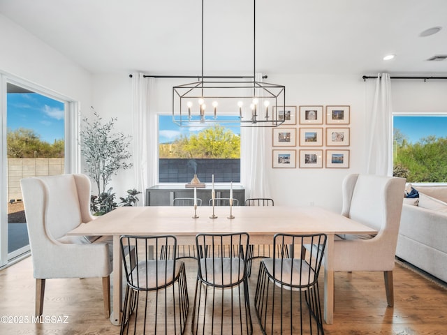 2540 W Oasis Springs Ct, Tucson, AZ 85742 - dining room with an inviting chandelier, a wealth of natural light, wood finished floors, and visible vents