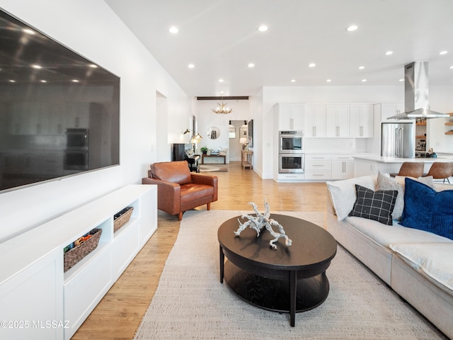 2540 W Oasis Springs Ct, Tucson, AZ 85742 - living room featuring recessed lighting, light wood finished floors, and a notable chandelier
