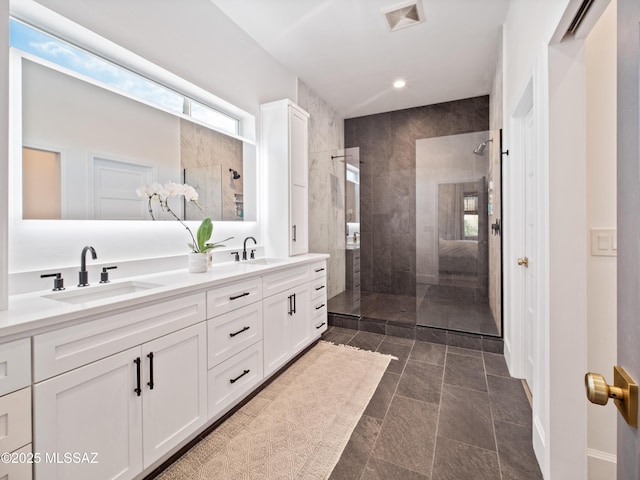 2540 W Oasis Springs Ct, Tucson, AZ 85742 - full bathroom featuring double vanity, a walk in shower, visible vents, and a sink