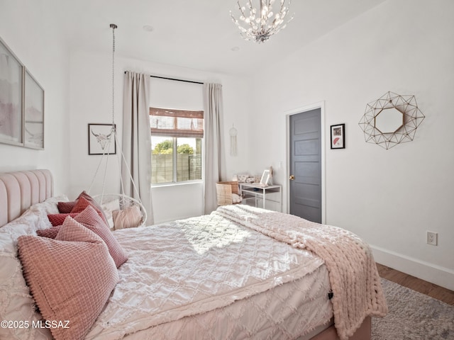 2540 W Oasis Springs Ct, Tucson, AZ 85742 - bedroom with baseboards, wood finished floors, and an inviting chandelier