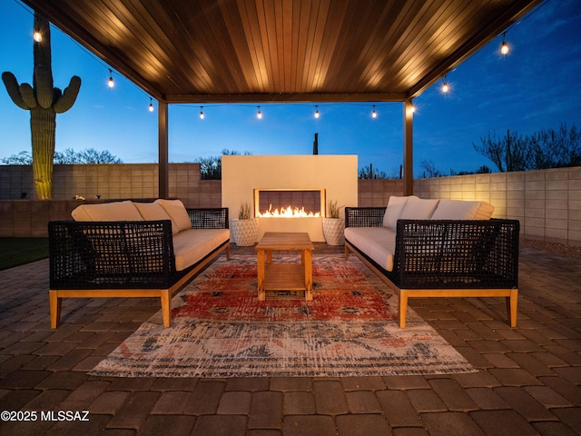 2540 W Oasis Springs Ct, Tucson, AZ 85742 - view of patio / terrace with a fenced backyard and an outdoor living space with a fireplace