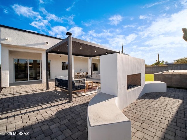 2540 W Oasis Springs Ct, Tucson, AZ 85742 - view of patio / terrace with fence and an outdoor living space with a fireplace
