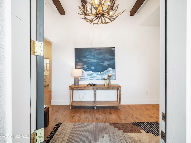 2540 W Oasis Springs Ct, Tucson, AZ 85742 - corridor featuring baseboards, beam ceiling, wood finished floors, and a chandelier