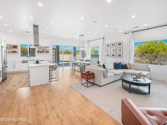 2540 W Oasis Springs Ct, Tucson, AZ 85742 - living room with light wood-type flooring, recessed lighting, and visible vents