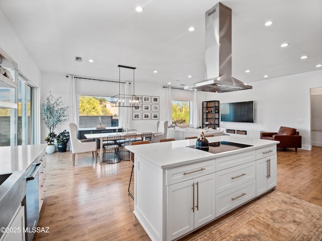 2540 W Oasis Springs Ct, Tucson, AZ 85742 - kitchen featuring island exhaust hood, open floor plan, black electric stovetop, and white cabinets