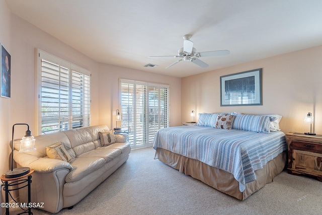 bedroom with ceiling fan, visible vents, access to outside, and carpet