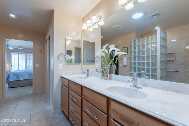 bathroom featuring visible vents, tile patterned flooring, double vanity, and a sink