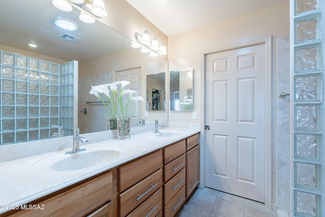 full bath with tile patterned flooring, a sink, double vanity, and visible vents