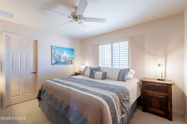 bedroom with visible vents, ceiling fan, and light carpet