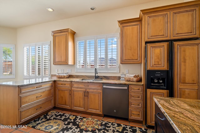 kitchen featuring brown cabinetry, dishwasher, a sink, and paneled built in fridge