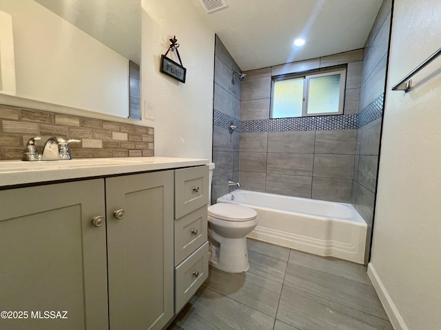 full bathroom with tile patterned flooring, decorative backsplash, toilet, vanity, and washtub / shower combination
