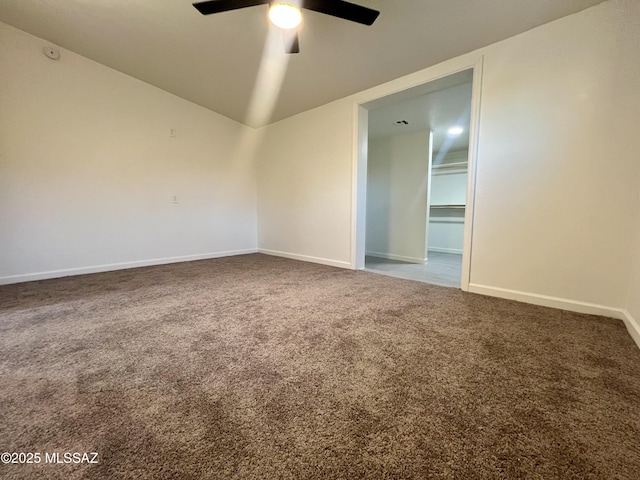 carpeted spare room featuring baseboards, ceiling fan, and lofted ceiling