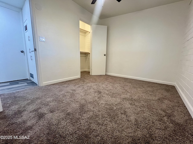 unfurnished bedroom featuring a ceiling fan, carpet, and baseboards