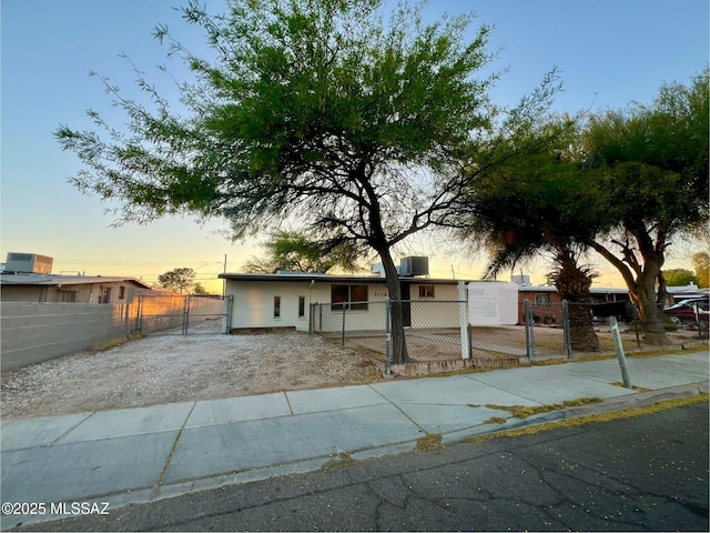 view of front of house with a fenced front yard and a gate