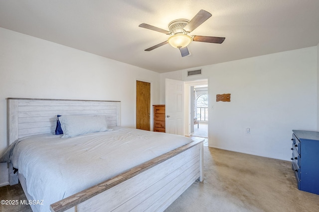 carpeted bedroom with visible vents and ceiling fan
