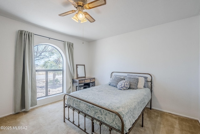 bedroom featuring multiple windows, carpet floors, and baseboards