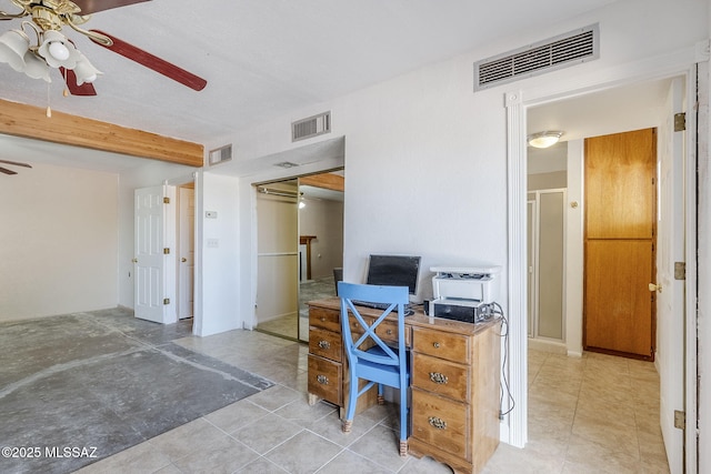 office space featuring tile patterned floors, visible vents, and a ceiling fan