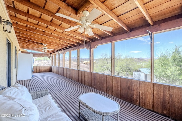 sunroom featuring ceiling fan and a healthy amount of sunlight