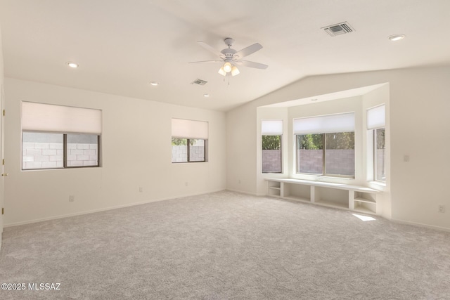carpeted spare room featuring visible vents, recessed lighting, a ceiling fan, and vaulted ceiling