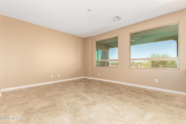 empty room featuring visible vents and baseboards