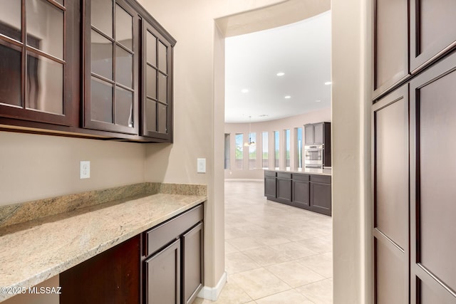 bar featuring recessed lighting, baseboards, and light tile patterned floors
