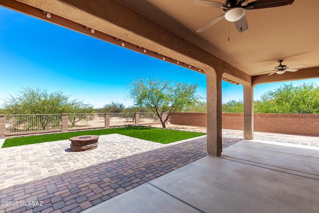 view of patio / terrace featuring a ceiling fan, a fire pit, and a fenced backyard