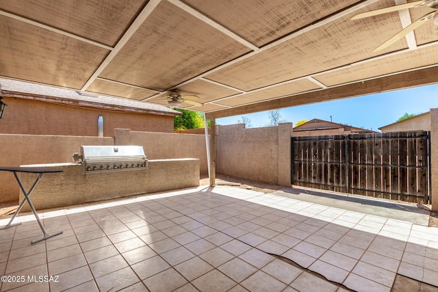 view of patio / terrace featuring fence, exterior kitchen, grilling area, and ceiling fan