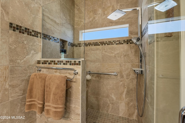 bathroom with tiled shower