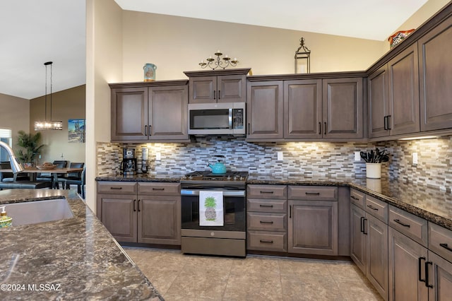 kitchen with stainless steel appliances, a sink, dark brown cabinets, an inviting chandelier, and decorative backsplash