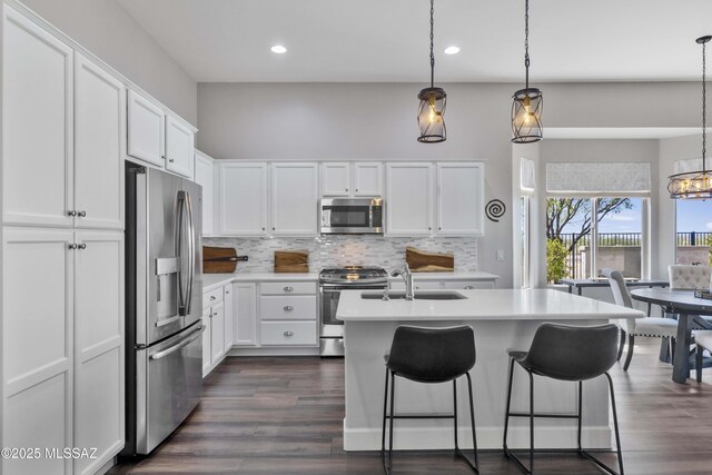 32968 S Cattle Trl, Oracle, AZ 85623 - kitchen featuring white cabinets, a sink, light countertops, stainless steel appliances, and tasteful backsplash