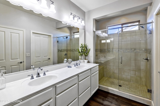 32968 S Cattle Trl, Oracle, AZ 85623 - full bathroom with wood finished floors, double vanity, a sink, and a stall shower
