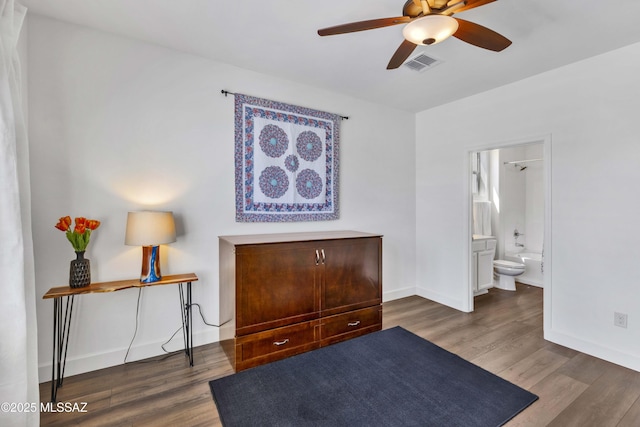 32968 S Cattle Trl, Oracle, AZ 85623 - bedroom with baseboards, connected bathroom, wood finished floors, and visible vents