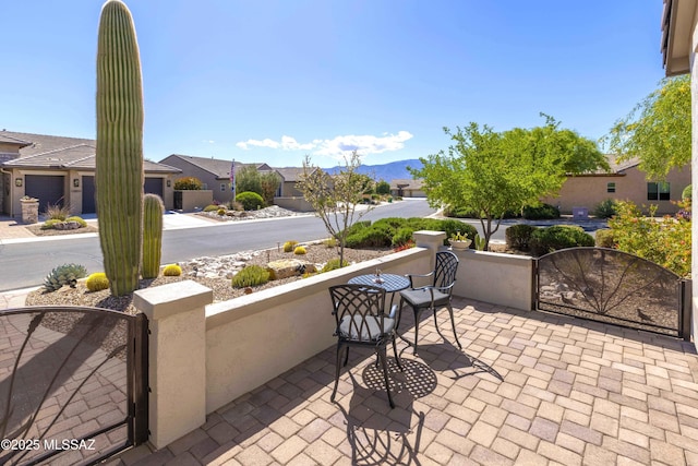 32968 S Cattle Trl, Oracle, AZ 85623 - view of patio featuring a residential view, a mountain view, a fenced front yard, and a gate