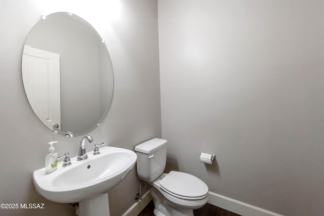 32968 S Cattle Trl, Oracle, AZ 85623 - bathroom with baseboards, a sink, wood finished floors, and toilet
