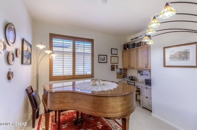 dining area with light colored carpet and baseboards
