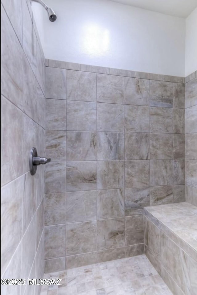 full bathroom featuring tiled shower