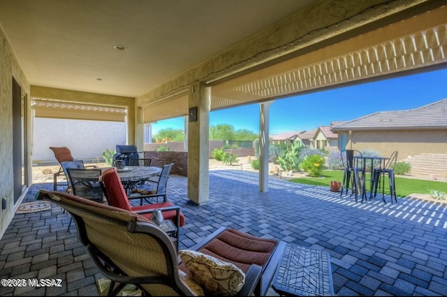 view of patio / terrace featuring a residential view, a fenced backyard, and outdoor dining space